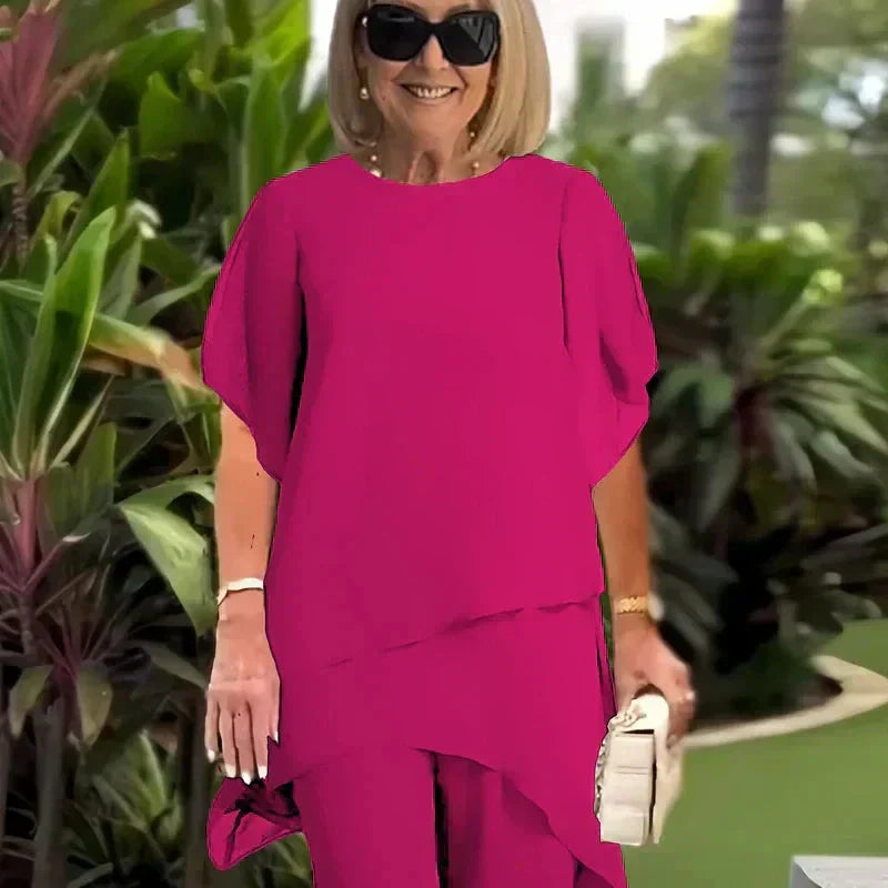 EB Conjunto elegante con top asimétrico y pantalones de pierna ancha.