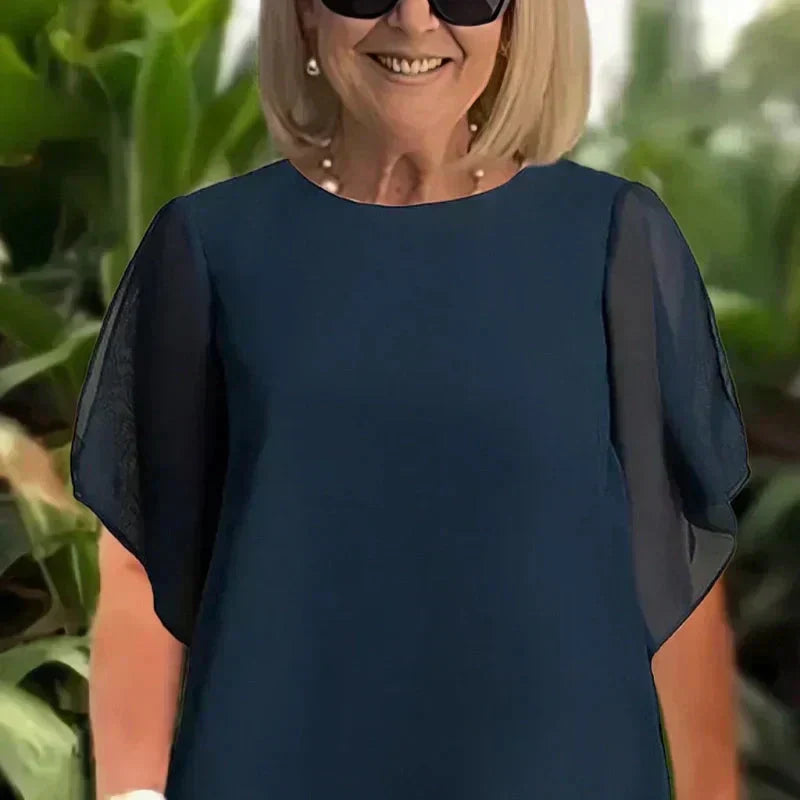 EB Conjunto elegante con top asimétrico y pantalones de pierna ancha.